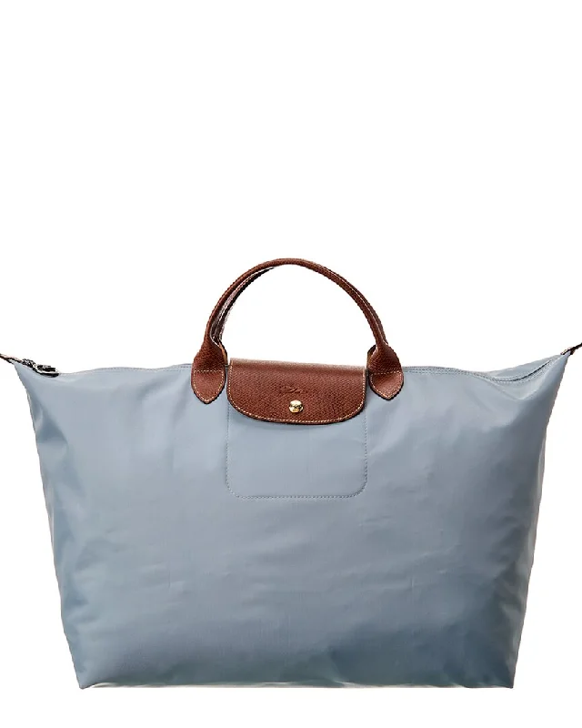 Compact Bags For Minimalist Travelers Longchamp Le Pliage Large Canvas Top Handle Tote The Best Handbag Deals Are Available Now Compact Bags For Minimalist Travelers Longchamp Le Pliage Large Canvas Top Handle Tote The Best Handbag Deals Are Available Now